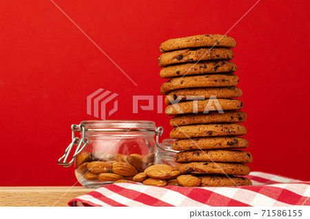 Chocolate chip cookies in stack on red background Chocolate chip cookies in stack on red background 71586155