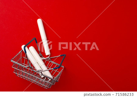 Shopping cart with medical tampons close up 71586233