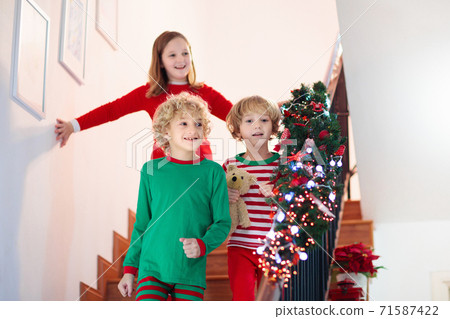 Kids running stair on Christmas morning 71587422