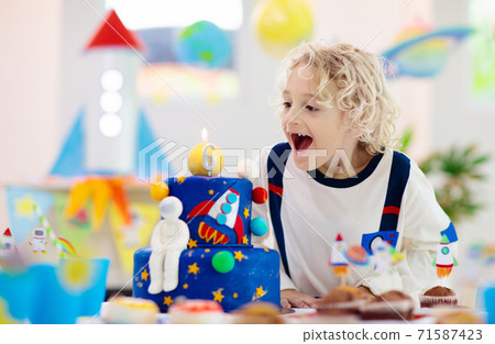 Kids space theme birthday party with cake. 71587423
