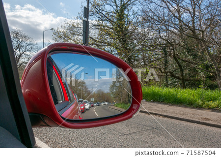 Heavy London traffic seen in the reflection of a car wing mirror Heavy London traffic seen in the reflection of a car wing mirror 71587504