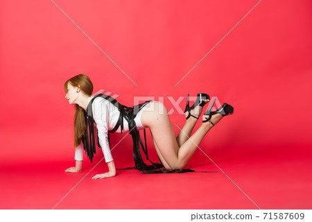 Young beautiful dancer posing in studio on red background Young beautiful dancer posing in studio on red background 71587609