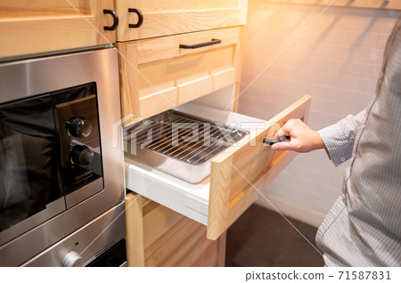 Male hand opening wooden drawer on kitchen Male hand opening wooden drawer on kitchen 71587831