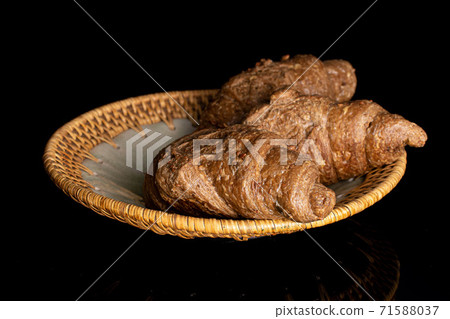 Baked croissant on black glass Baked croissant on black glass 71588037