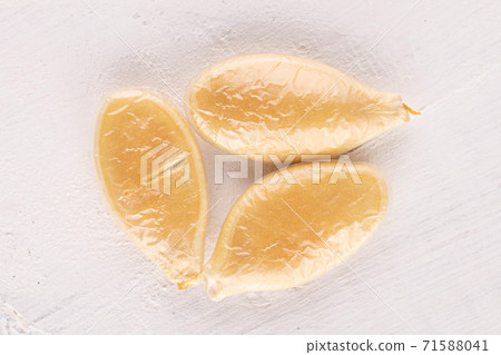 Pumpkin seed on white wood 71588041