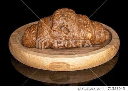 Baked croissant on black glass Baked croissant on black glass 71588045