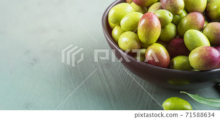 Freshly picked raw green olives in black bowl Freshly picked raw green olives in black bowl 71588634