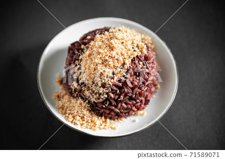Black rice or organic rice berry with roasted coconut crust or Prik Gub Klur - authentic Thai local cuisine Black rice or organic rice berry with roasted coconut crust or Prik Gub Klur - authentic Thai local cuisine 71589071