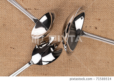 Steel cutlery on linen Steel cutlery on linen 71589314