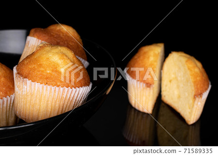 Baked muffin on black glass 71589335