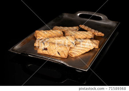 Flat puff cookie on black glass 71589368