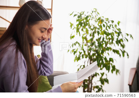 Woman opening, recieving greeting card for New Year and Christmas 2021 from friends or family Woman opening, recieving greeting card for New Year and Christmas 2021 from friends or family 71590563