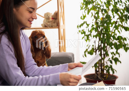 Woman opening, recieving greeting card for New Year and Christmas 2021 from friends or family 71590565