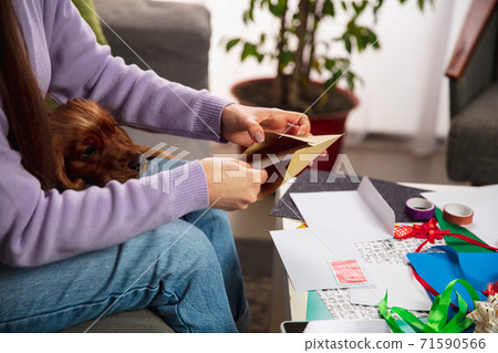 Woman opening, recieving greeting card for New Year and Christmas 2021 from friends or family Woman opening, recieving greeting card for New Year and Christmas 2021 from friends or family 71590566