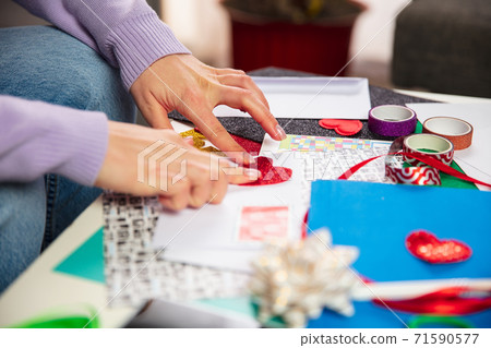 Woman making greeting card for New Year and Christmas 2021 for friends or family, scrap booking, DIY Woman making greeting card for New Year and Christmas 2021 for friends or family, scrap booking, DIY 71590577