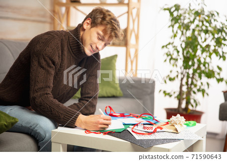 Man making greeting card for New Year and Christmas 2021 for friends or family, scrap booking, DIY Man making greeting card for New Year and Christmas 2021 for friends or family, scrap booking, DIY 71590643