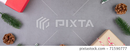 Christmas holiday composition with red gift box decoration on cement floor background. 71590777