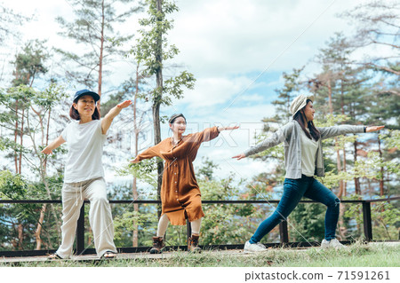 Asian women doing yoga in the campsite/forest (outdoor) Asian women doing yoga in the campsite/forest (outdoor) 71591261