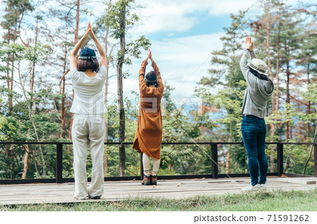 Asian women doing yoga in the campsite/forest (outdoor) Asian women doing yoga in the campsite/forest (outdoor) 71591262