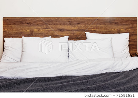 Modern bedroom interior. Bed with wooden headboard Modern bedroom interior. Bed with wooden headboard 71591651