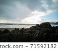 Overlooking the ocean from the rocks on a cloudy day at Caswell Bay Beach towards winter. 71592182