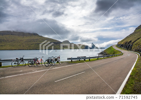 Bicycles parked near high slope iconic road in Faroe Islands 71592745