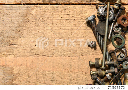 old vintage hand tools - set of screws and nuts on a wooden background with blank space for text old vintage hand tools - set of screws and nuts on a wooden background with blank space for text 71593172