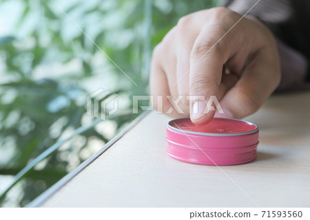 woman using petroleum jelly onto skin at home close up. woman using petroleum jelly onto skin at home close up. 71593560