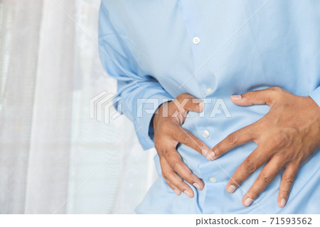 young man suffering stomach pain close up. young man suffering stomach pain close up. 71593562