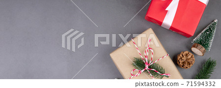 Christmas holiday composition with red gift box decoration on cement floor background. 71594332