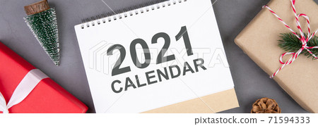 Christmas holiday with gift box and calendar 2021 decoration on cement floor background. 71594333