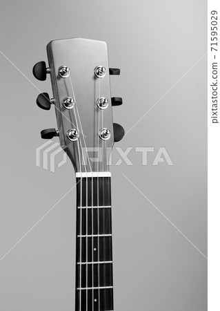 The fretboard of an acoustic guitar closeup. Studio photo of a musical instrument. Mockup The fretboard of an acoustic guitar closeup. Studio photo of a musical instrument. Mockup 71595029
