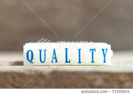 Letter block with blue color word quality on wood background Letter block with blue color word quality on wood background 71595631