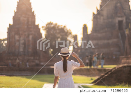 Tourist Woman in white dress visiting to ancient stupa in Wat Chaiwatthanaram temple in Ayutthaya Historical Park, summer, Asia and Thailand travel concept Tourist Woman in white dress visiting to ancient stupa in Wat Chaiwatthanaram temple in Ayutthaya Historical Park, summer, Asia and Thailand travel concept 71596465