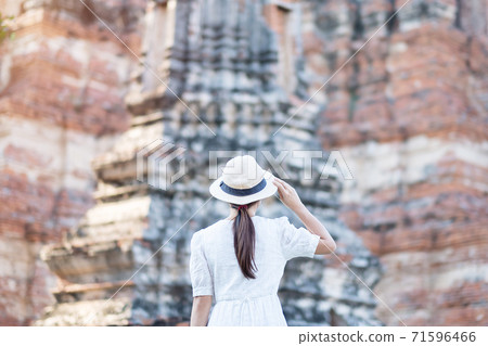 Tourist Woman in white dress visiting to ancient stupa in Wat Chaiwatthanaram temple in Ayutthaya Historical Park, summer, Asia and Thailand travel concept Tourist Woman in white dress visiting to ancient stupa in Wat Chaiwatthanaram temple in Ayutthaya Historical Park, summer, Asia and Thailand travel concept 71596466