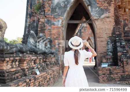 Tourist Woman in white dress visiting to ancient stupa in Wat Chaiwatthanaram temple in Ayutthaya Historical Park, summer, Asia and Thailand travel concept Tourist Woman in white dress visiting to ancient stupa in Wat Chaiwatthanaram temple in Ayutthaya Historical Park, summer, Asia and Thailand travel concept 71596499