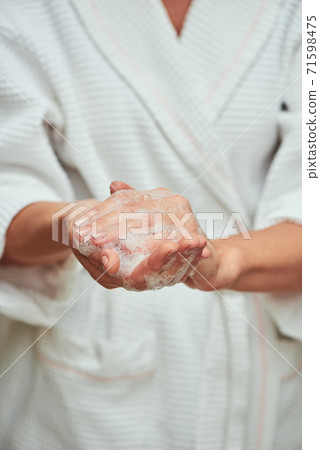 Woman washing hands with soap foam 71598475
