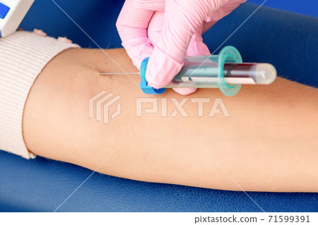 Nurse takes blood from vein. Nurse takes blood from vein. 71599391