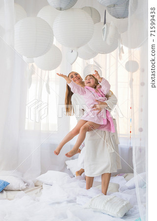 Woman and children on bed. Woman and children on bed. 71599438