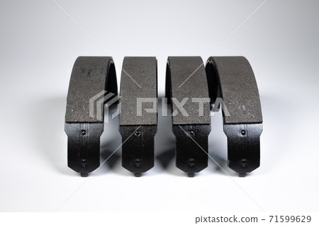 New set of four brake pads for drum brakes on a gray background New set of four brake pads for drum brakes on a gray background 71599629