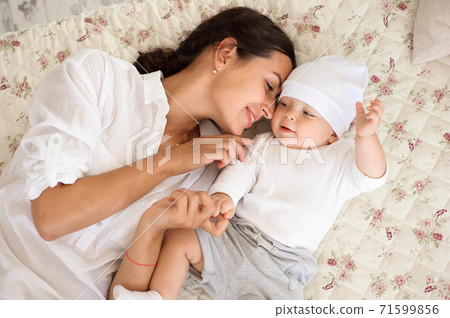 Happy loving family. Young mother are playing with her baby boy 71599856