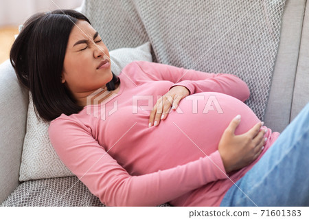 Pregnant Chinese Lady Suffering From Pain Touching Belly At Home Pregnant Chinese Lady Suffering From Pain Touching Belly At Home 71601383