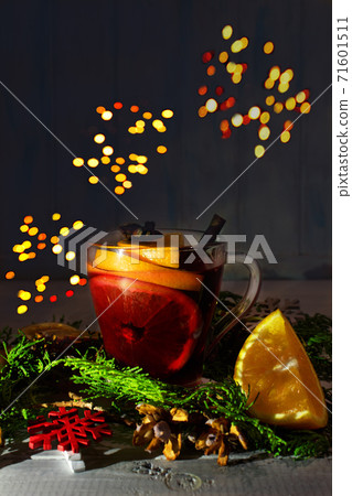 Home made mulled wine. Glass with orange slices, cinnamon sticks, cloves, cherry juce on white wooden background.  71601511