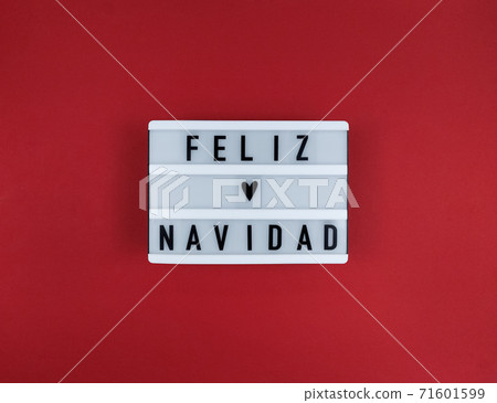 Light box with Feliz Navidad phrase, Spanish Merry Christmas on a red background. Light box with Feliz Navidad phrase, Spanish Merry Christmas on a red background. 71601599