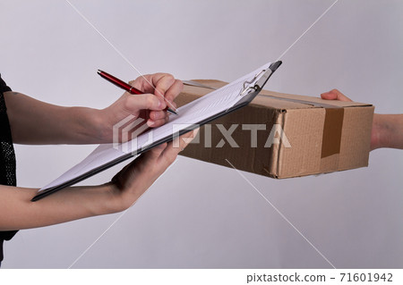 Detailed view of a customer signing delivery note. Detailed view of a customer signing delivery note. 71601942
