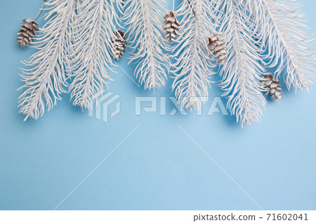 Merry Christmas and Happy New Year greeting card branches frame or banner. Fir tree on blue background top view. Winter holiday theme Merry Christmas and Happy New Year greeting card branches frame or banner. Fir tree on blue background top view. Winter holiday theme 71602041