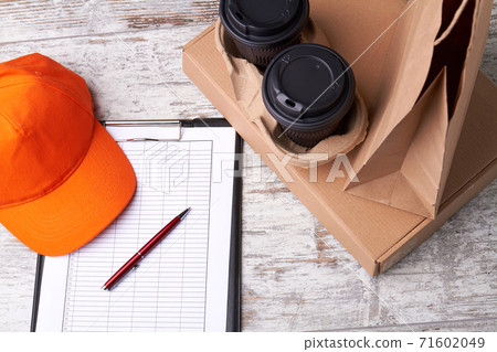 Delivery documents with pen and coffee. Delivery documents with pen and coffee. 71602049