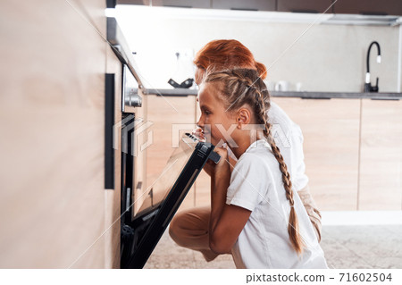 Mom and daughter cooking on kitchen 71602504