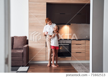 Mother embracing her little daughter 71602513