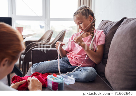Girl examines measuring type 71602643